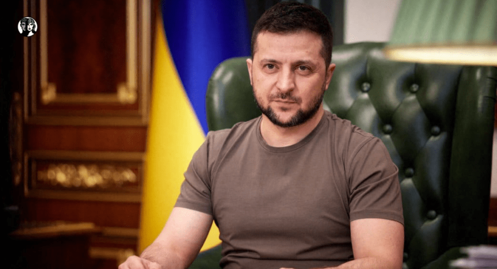Man seated in green leather chair.